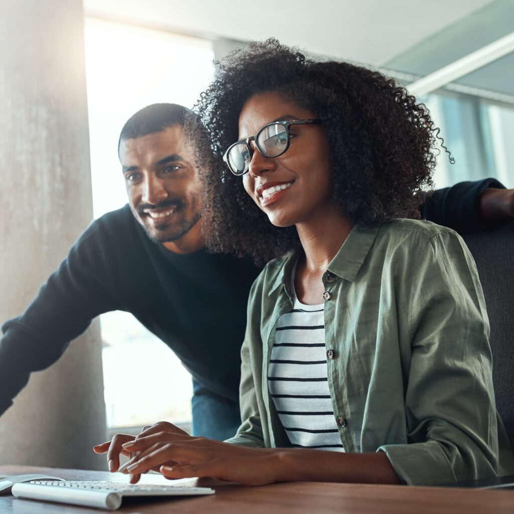 Two charity employees using Google for Nonprofit UK through Encompass Innovate, offering productivity applications for free.